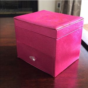 Pink satin jewelry box filled with jewelry